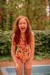 © Lesia - The girl and the pool. A teenager in a positive mood laughs on vacation in a swimsuit.