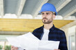 young contractor man holding blueprints