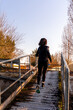 © Marino Bocelli - young adult woman is running on a ship gangway in the morning