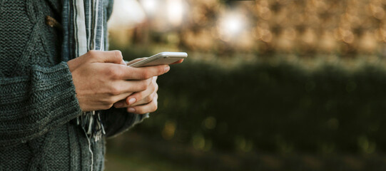 hands with mobile phone outdoors