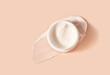 © Liudmila - White smeared cream or cosmetic face mask with the open cosmetic jar.  Purifying and moisturizing cream. Flat lay