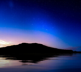 Wall Mural - starry skies over coastline silhouette