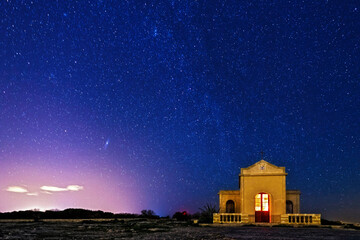 Wall Mural - night sky over chapel at mellieha in malta