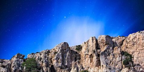 Wall Mural - rocky cliffs and night sky in malta