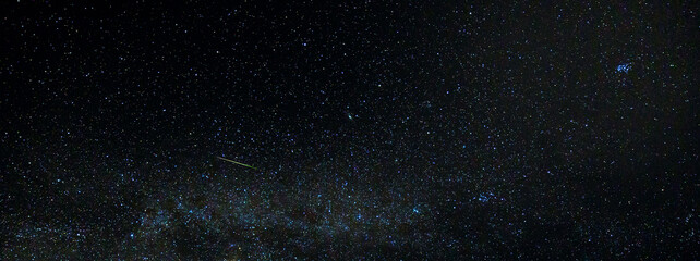 Wall Mural - a meteor streaks across the sky near the milky way