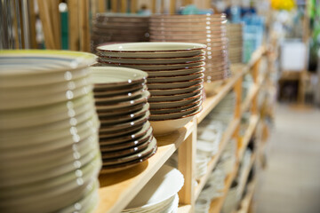 Wall Mural - Various ceramic plates for sale in tableware department of home furnishings store..