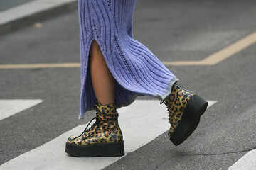 Wall Mural - woman wearing knitted purple skirt and leopard print shoes