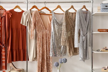 Wall Mural - Stylish dresses hanging in wardrobe in dressing room