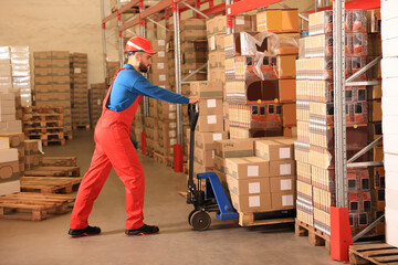 Poster - Worker with pallet jack at warehouse. Logistics center