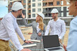 © zinkevych - Concentrated building inspector communicating with builders outdoors