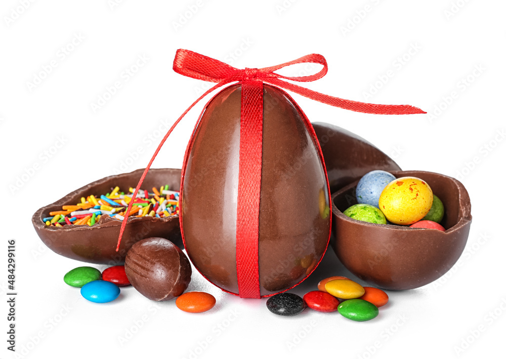 Chocolate Easter eggs with sprinkles and candies on white background