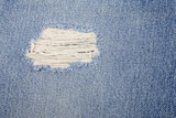 Fototapeta Tęcza - Blue torn denim jeans texture.