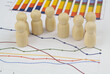 Management, demography and statistics concept. People figures on financial graphs close up.