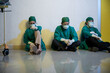 © sorapop - Tired doctor, Group of surgery doctors sadness fatigue after surgery, emotional sitting stress of overworked doctor and medical care team during covid-10, Surgical team tired after operation