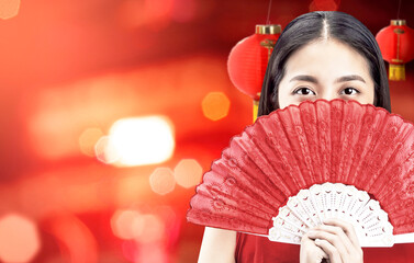 Poster - Asian Chinese woman in a cheongsam dress holding fan celebrates Chinese New Year