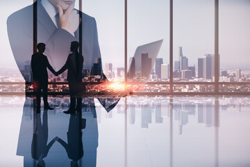 Canvas Print - Abstract image of businessman using laptop in modern office interior with panoramic city view, businesspeople shaking hands and mock up place. Teamwork, leadership and technology concept.