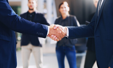 Poster - Congratulations, lets do this. Cropped shot of two unrecognizable businesspeople shaking hands while in the office during the day.