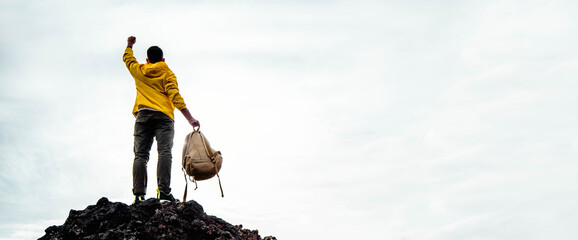 Canvas Print - Happy man with open arms standing on the top of mountain - Hiker with backpack celebrating success outside - People, success and sport concept