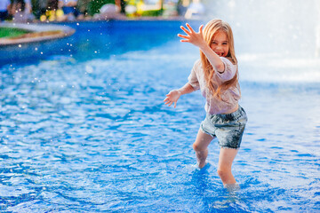 pretty girl having fun in the pool	
