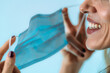 © Microgen - Smiling woman taking off face mask