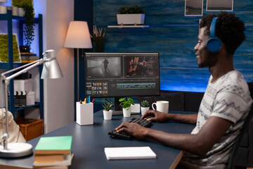 Wall Mural - Video maker editor man man working remote from home at montage film editing visual effects using post production software. Filmmaker artist designing creative content in creativity studio