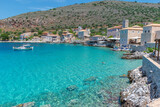 Fototapeta  - view of  Limeni village with the  turquoise waters and the stone buildings as a background  in Mani, South Peloponnese , Greece.