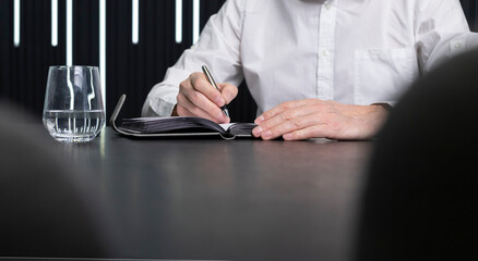 Poster - Man hands writing in diary. Employee sitting at office desk. Business planning concept. . High quality photo