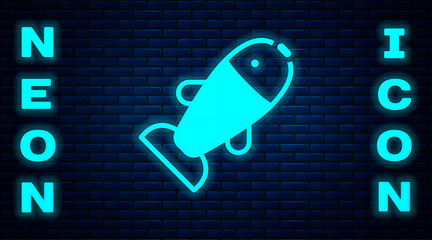 Poster - Glowing neon Fish icon isolated on brick wall background. Vector