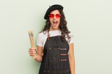 Wall Mural - young pretty hispanic woman shouting aggressively, looking very angry. artist concept