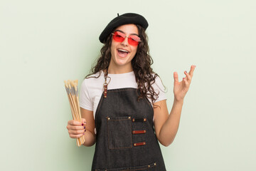 Wall Mural - young pretty hispanic woman feeling happy, surprised realizing a solution or idea. artist concept