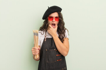 Wall Mural - young pretty hispanic woman with mouth and eyes wide open and hand on chin. artist concept