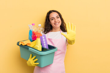 Wall Mural - young pretty hispanic woman smiling and looking friendly, showing number five. housework an clean products concept