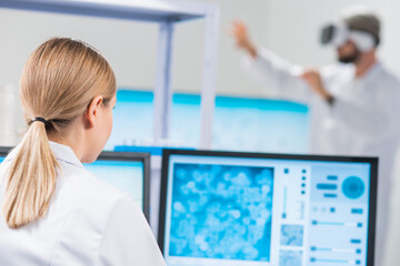 Wall Mural - genetic engineers are using virtual reality technology. professional team of scientists is working o