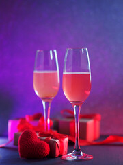 Canvas Print - Romantic Valentine's day card. Two glasses of wine or cider, a red knitted heart and gift boxes. Neon backlight