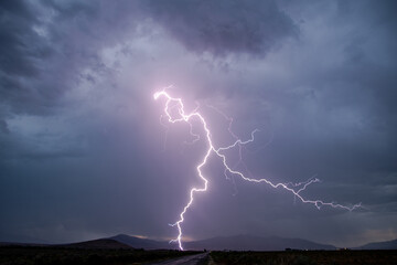 Wall Mural - Lightning striking the ground during rain storm