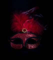 Poster - carnival symbol mask in red gold color with feathers on black background