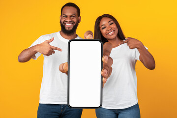 Poster - Black couple showing white empty smartphone screen, closeup