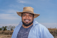 Portrait Of A Mexican Happy Farmer Collecting Corn