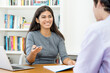 © Daniel Ernst - Laughing south american business trainee talking with colleague