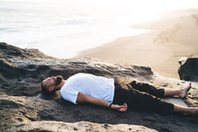 Bearded Man With Closed Eyes Lysing And Resting During Pastime For Pranayama Breathing In Nature Environment, Caucaisan Male Yogi Feeling Mindfulness Enlightenment During Holistic Healing And Retreat