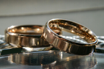 scratched wedding rings on a shiny metal surface. selective focus