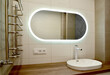 Large oval mirror and overhead washbasin in the bathroom