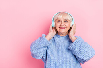 Sticker - Portrait of attractive dreamy cheerful grey-haired woman listening stereo sound copy space isolated over pink pastel color background