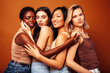 © iordani - young pretty caucasian, african, scandinavian woman posing cheerful together on brown background, lifestyle diverse nationality people concept