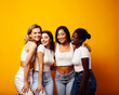© iordani - diverse multi nation girls group, teenage friends company cheerful having fun, happy smiling, cute posing on yellow background, lifestyle people concept, african-american, asian and caucasian