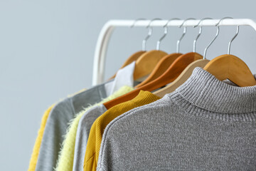 Wall Mural - Rack with clean sweaters on color background