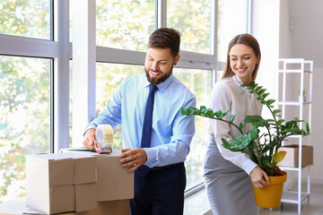 Wall Mural - Business colleagues packing things in office on moving day