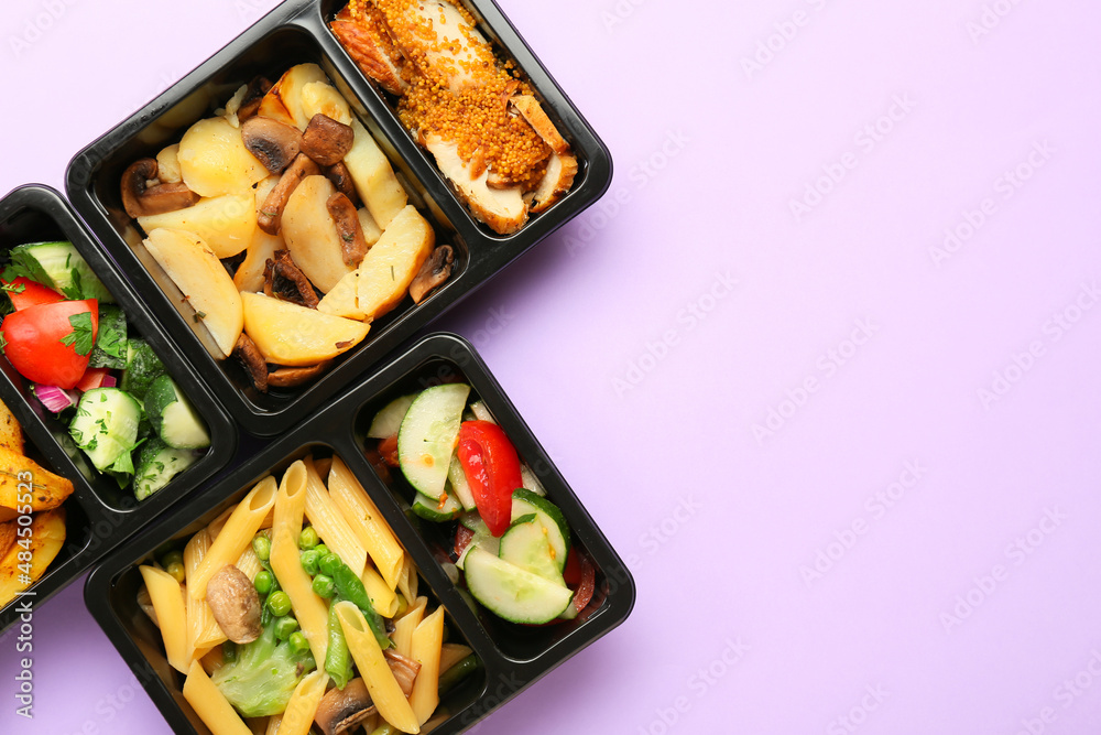 Food containers with different meals on color background, closeup
