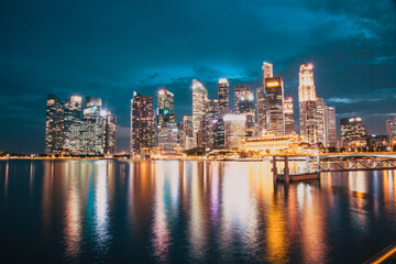 Wall Mural - SINGAPORE, SINGAPORE - MARCH 2019: Skyline of Singapore Marina Bay at night with Marina Bay sands, Art Science museum , skyscrapers and tourist boats