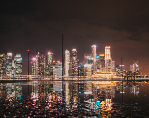 Wall Mural - SINGAPORE, SINGAPORE - MARCH 2019: Skyline of Singapore Marina Bay at night with Marina Bay sands, Art Science museum , skyscrapers and tourist boats